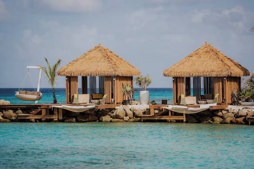 Thatched overwater cabanas with loungers